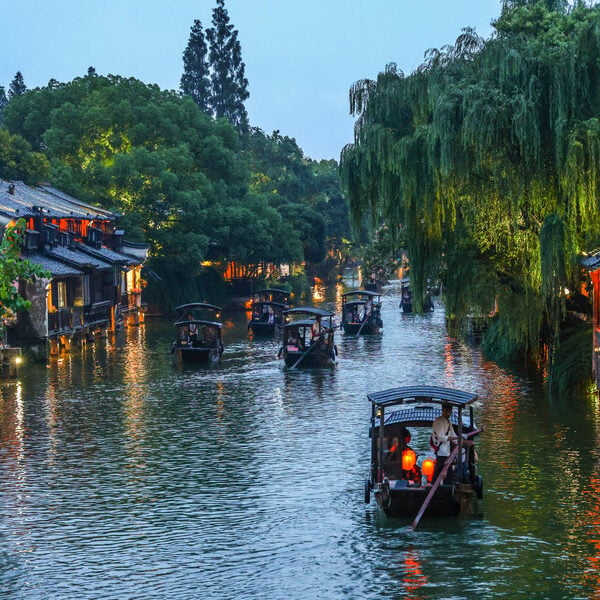 Illuminated traditional canal buildings in Wuzhen Xizha at night