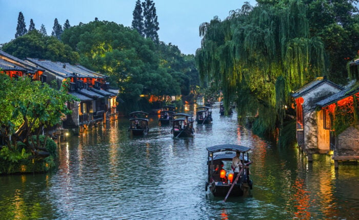Illuminated traditional canal buildings in Wuzhen Xizha at night