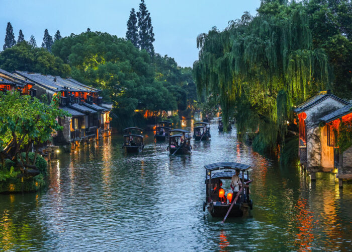 Illuminated traditional canal buildings in Wuzhen Xizha at night
