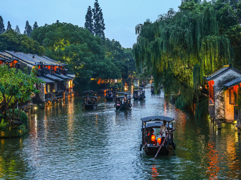 Illuminated traditional canal buildings in Wuzhen Xizha at night