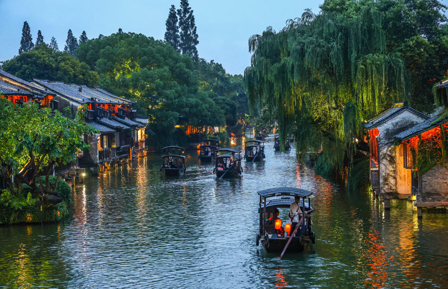 Illuminated traditional canal buildings in Wuzhen Xizha at night