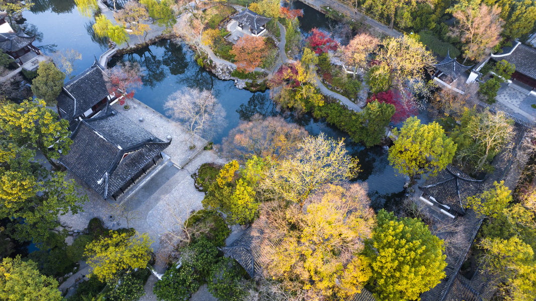 Garden buildings among autumn trees at the Humble Administrator’s Garden in Suzhou.
