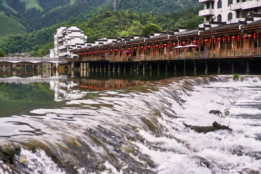 Riverside buildings and a stone crossing at Yaoli Ancient Town near Jingdezhen